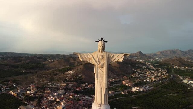 Aerial view traveling out of a statue of Jesus Christ. Cristo de Monteagudo, Murcia, Spain. It begins in the heart of Christ and ends with the general plan.