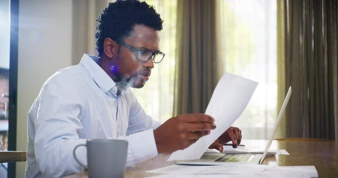 Stress, laptop and black man with mortgage paper document, taxes or bills for online payment at home. Confused, digital and African person in debt with financial pressure, loan or money problems