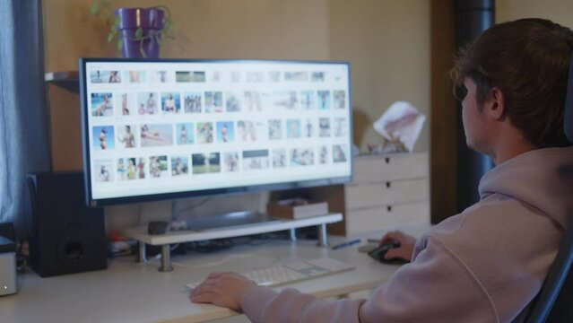 Young mand watching naked women in the computer screen	