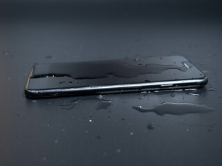 Close-up of an old telephone in water on a black background.