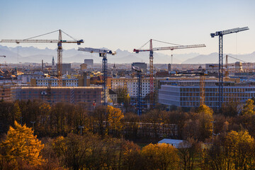 MUNICH, GERMANY - NOVEMBER 23, 2022: Panoramic city view with cranes from sevaral construction sites stickeing out