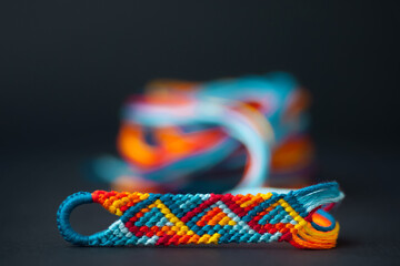 Friendship bracelet in the process of being made - with a beautiful blurry background