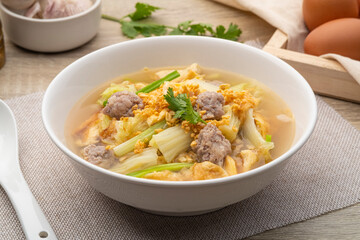 Clear soup with fried egg and minced pork ,Chinese Cabbage in white bowl
