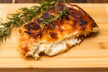 Homemade cheese pie, one piece on cutting board