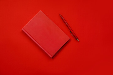 Red block with a handle on a red background. Items on the red table. Red background place for text