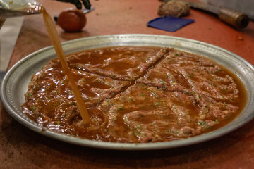 Pouring Tomato Sauce to Tray Kebab