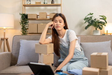 Young entrepreneur is feeling disappointed and bored after checking online order while sitting on the couch