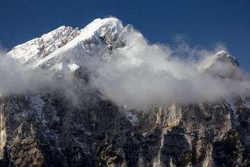Fototapeta na wymiar Julian Alps Slovenia, peak Debela Pec 2014 m, winter hiking in Triglav with snowy peaks and mist 
