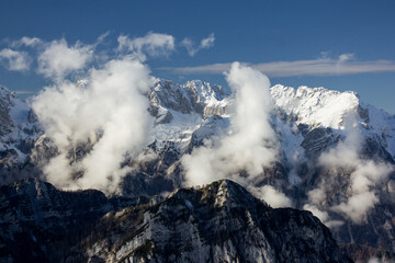 Julian Alps Slovenia, peak Debela Pec 2014 m, winter hiking in Triglav with snowy peaks and mist 