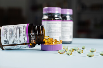 Nutritionist holding in hands omega 3 and vitamin D biologically active additives BAA. Dietary Supplements for correct the structure of human nutrition and to prevent certain diseases.