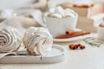 Atmospheric whiite cozy marshmallows, hot cocoa at cozy home. Aesthetic white Christmas food background