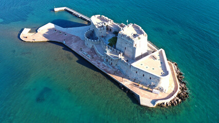 Aerial drone photo of iconic fortress of Bourtzi built in small islet in gulf of Argolida used as a prison in old times, Nafplio, Peloponnese, Greece