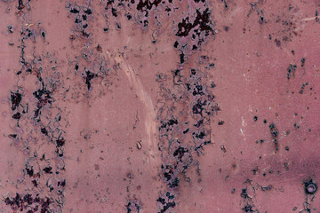 Damaged metallic weathered wall with rust and peeled paint. Detail of an aged iron cracked surface