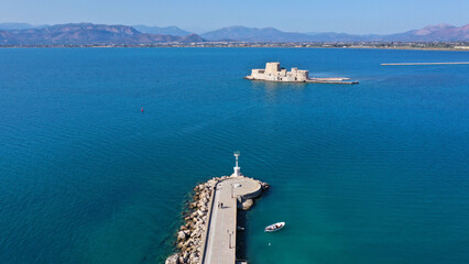 Aerial drone photo of iconic fortress of Bourtzi built in small islet in gulf of Argolida used as a prison in old times, Nafplio, Peloponnese, Greece