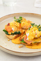 Portion of eggs benedict toast with salmon and herbs breakfast