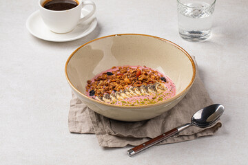 Portion of gourmet granola breakfast with banana and berry yoghurt