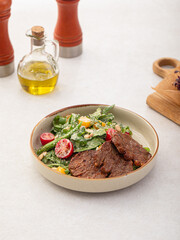 Portion of gourmet salad with roast beef