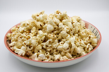 Popcorn on a plate on a white background