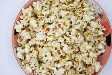 Popcorn on a plate on a white background