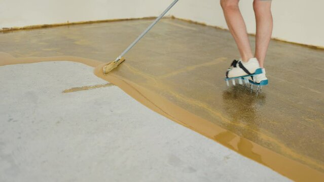 Worker spreading the epoxy on the floor