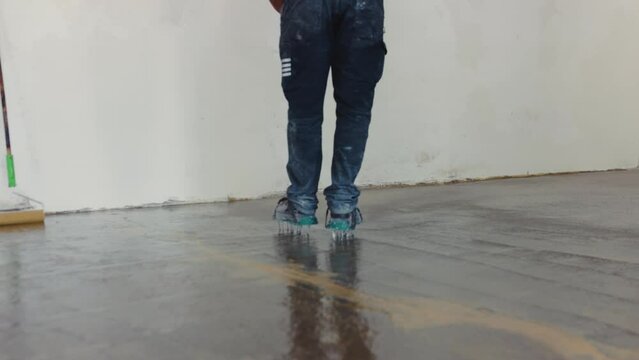 Worker spreading the epoxy on the floor