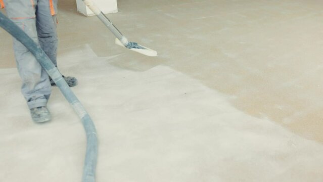 Worker spreading the epoxy on the floor