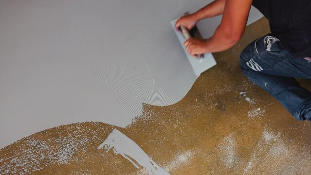 Worker spreading the epoxy on the floor