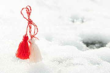 Martisor and Baba Marta. Symbols of spring. of rope on a snow background. Wallpaper of spring...