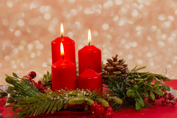 Advent - four red candles with a Christmas ornament. Third candle, shepherd's candle
