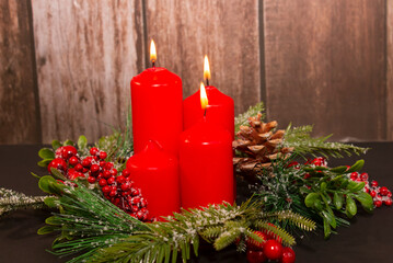 Advent - four red candles with a Christmas ornament. Third candle, shepherd's candle