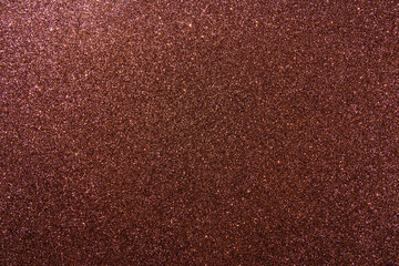 Background with sparkles. Backdrop with glitter. Shiny textured surface. Dark moderate red