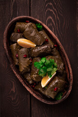 Dolma (Tolma) stuffed rolls, minced meat with rice, in grape leaves, top view, no people, close-up,