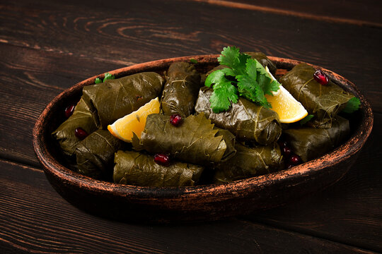 Dolma (Tolma) stuffed rolls, minced meat with rice, in grape leaves, top view, no people, close-up,