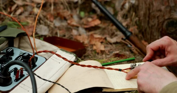 Russian Soviet Infantry Red Army Soldier In World War II using Russian Soviet Portable Radio Transceiver In Trench Entrenchment In Spring Autumn Forest. 4K. Headphones And Telegraph Key. Close Up