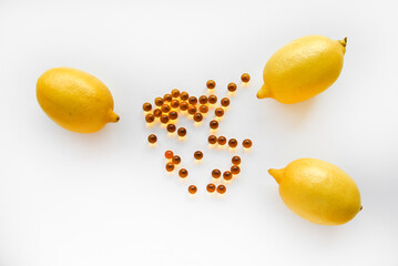 Ripe yellow lemons on a white background. Lemons and medicine in yellow ampoules. Citric acid in...