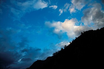 silhouette of a mountain at dusk with beautiful cloud sky
