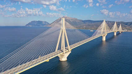 Obraz premium Aerial drone photo of famous state of the art modern cable strait bridge of Rio Antirio crossing corinthian gulf from Peloponnese seaside city of Rio to Antirio - mainland Greece