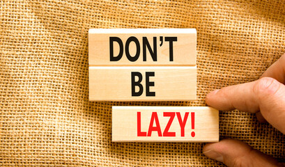 Motivational and do not be lazy symbol. Concept words Do not be lazy on wooden blocks on a beautiful canvas table canvas background. Businessman hand. Business do not be lazy concept. Copy space.