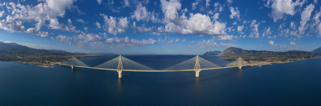 Aerial drone panoramic photo of famous state of the art modern cable strait bridge of Rio Antirio crossing corinthian gulf from Peloponnese seaside city of Rio to Antirio - mainland Greece