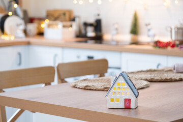 Festive Christmas decor and mess in the light kitchen, festive breakfast, white scandi interior. New Year, mood, cozy home 