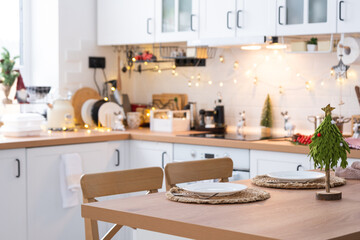 Festive Christmas decor and mess in the light kitchen, festive breakfast, white scandi interior. New Year, mood, cozy home 