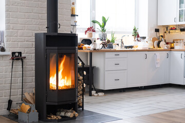 Festive interior of house is decorated for Christmas and New Year in loft style with black stove,...