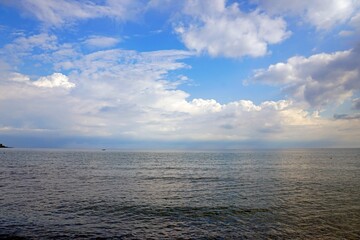 Fototapeta premium Aegean Sea in Crete. White clouds and blue sky. Sea distances and the horizon.