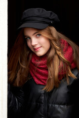 girl in a black cap with a red scarf close-up portrait