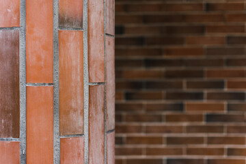Pillar and wall made of red brick stones. Architecture background or backdrop