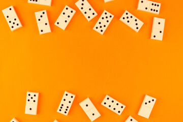 White dominoes randomly arranged on an orange background
