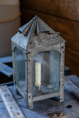 Vintage galvanized steel lantern with candle inside in a  building at Fort Alexandria represents a...