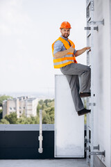 Builder standing on the roof of a construction