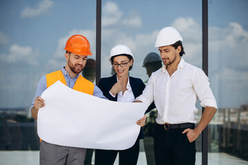 Business people and engineer talking on the roof of the building