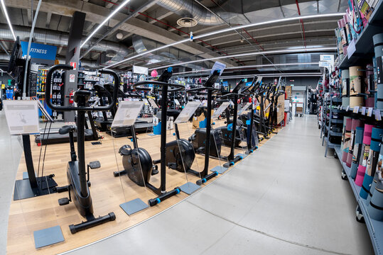 Cuneo; Italy - November 22; 2022: large assortment of stationary bikes for indoor biking exercise displayed in fitness department in italian Decathlon store; fish eye view
